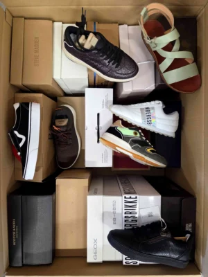 The photo shows a package with footwear in the category AS.