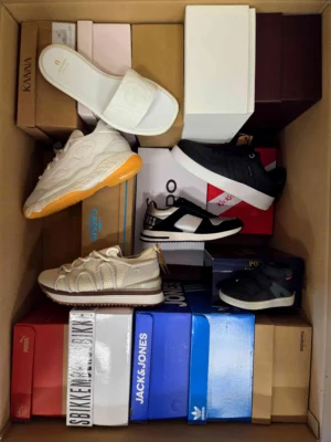 The photo shows a package with footwear in the category AS.