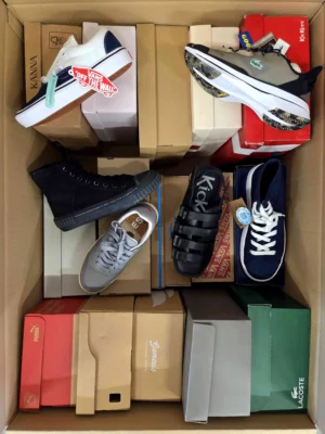 The photo shows a package with footwear in the category AS.