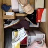 The photo shows a package with footwear in the category AS.