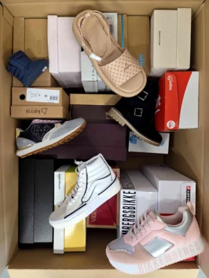 The photo shows a package with footwear in the category AS.