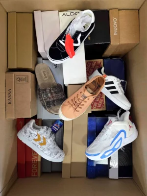 The photo shows a package with footwear in the category AS.