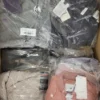 The photo shows a package with clothing in the category AJS.