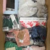 The photo shows a package with clothing in the category AU.