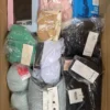 The photo shows a package with clothing in the category AU.