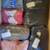 The photo shows a package with clothing in the category AJS.