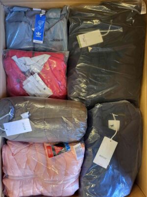 The photo shows a package with clothing in the category AJS.