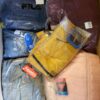 The photo shows a package with clothing in the category AJS.