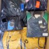 The photo shows a package with clothing in the category AJS.