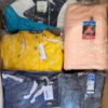 The photo shows a package with clothing in the category AJS.