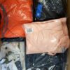 The photo shows a package with clothing in the category AJS.