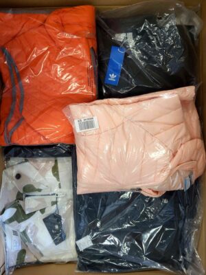 The photo shows a package with clothing in the category AJS.