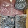 The photo shows a package with clothing in the category AJS.