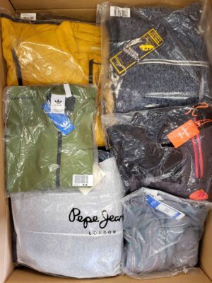 The photo shows a package with clothing in the category AJS.