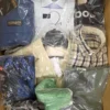 The photo shows a package with clothing in the category AM.