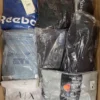 The photo shows a package with clothing in the category AM.