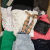 The photo shows a package with clothing in the category TSC.