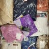 The photo shows a package with clothing in the category AW.