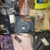 The photo shows a package with clothing in the category AW.