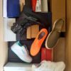 The photo shows a package with footwear in the category AS.