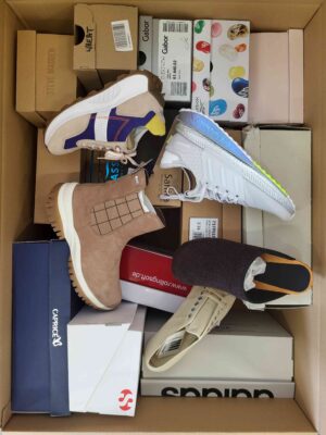 The photo shows a package with footwear in the category AS.
