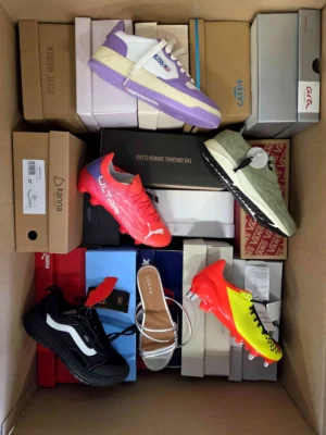 The photo shows a package with footwear in the category AS.