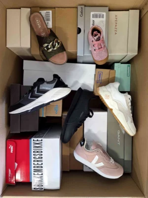 The photo shows a package with footwear in the category AS.