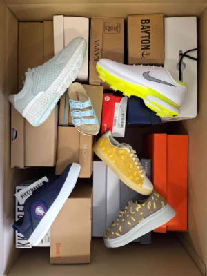 The photo shows a package with footwear in the category AS.