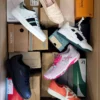 The photo shows a package with footwear in the category AS.