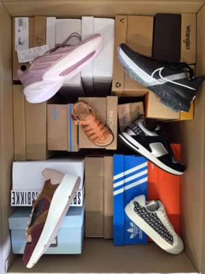 The photo shows a package with footwear in the category AS.