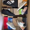 The photo shows a package with footwear in the category AS.