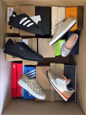 The photo shows a package with footwear in the category AS.