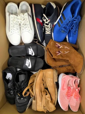The photo shows a package with footwear in the category SH.