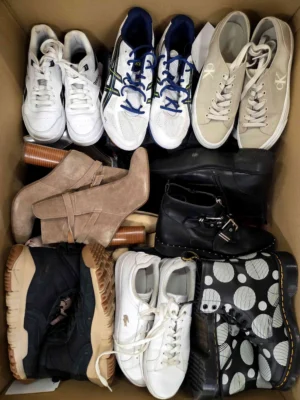 The photo shows a package with footwear in the category SH.