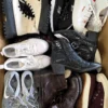 The photo shows a package with footwear in the category SH.