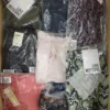 The photo shows a package with clothing in the category AW.