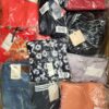 The photo shows a package with clothing in the category AW.