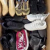 The photo shows a package with footwear in the category SH.