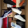 The photo shows a package with footwear in the category AS.