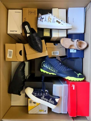 The photo shows a package with footwear in the category AS.