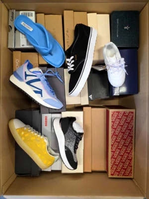 The photo shows a package with footwear in the category AS.
