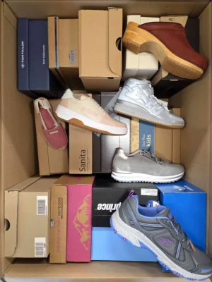 The photo shows a package with footwear in the category AS.