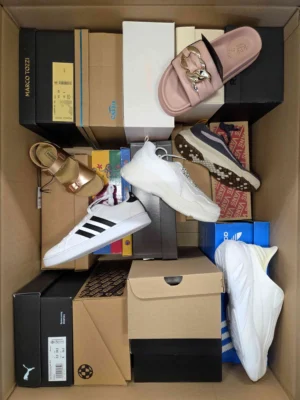 The photo shows a package with footwear in the category AS.