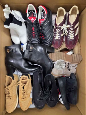 The photo shows a package with footwear in the category SH.