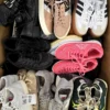 The photo shows a package with footwear in the category SH.