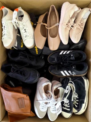 The photo shows a package with footwear in the category SH.