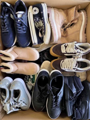 The photo shows a package with footwear in the category SH.