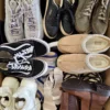 The photo shows a package with footwear in the category SH.