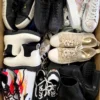 The photo shows a package with footwear in the category SH.
