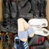 The photo shows a package with footwear in the category SH.
